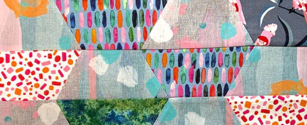 Scrappy half square hexagon quilt